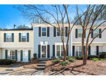 Charming townhome with a well-manicured front yard and a welcoming entrance at 2003 Queen Anne Ct, Sandy Springs, GA 30350