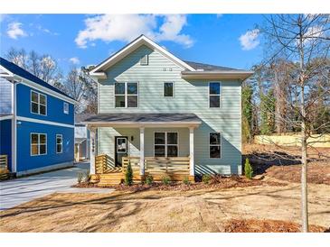 Charming two-story home with a welcoming front porch and newly landscaped yard at 1098 Wedgewood Nw Dr, Atlanta, GA 30318
