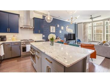 Modern kitchen featuring granite counters, stainless steel appliances, island and hardwood floors at 589 Broadview Ne Pl, Atlanta, GA 30324