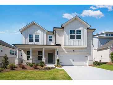 Charming two-story home with a landscaped front yard, brick facade and a two-car garage at 1466 Auburn Glen Rd, Dacula, GA 30019