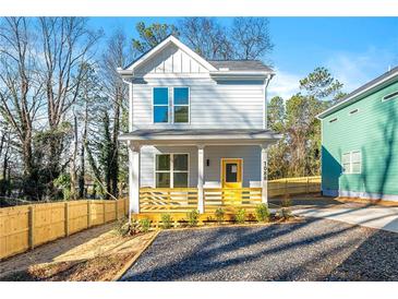 Charming two-story home with light blue siding, yellow front door, and a wooden porch at 1088 Wedgewood Nw Dr, Atlanta, GA 30318