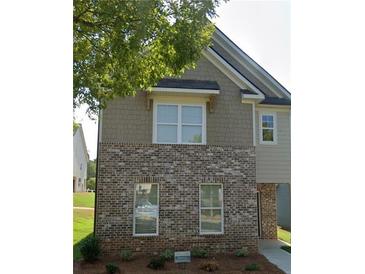 Charming townhome featuring brick facade, neutral siding and well-maintained landscaping at 1908 Stanton Rd, East Point, GA 30344