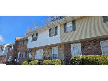 A multi-Gathering residential dwelling showcases traditional brick and siding with a stone foundation at 501 Carlton Rd # 3F, Palmetto, GA 30268