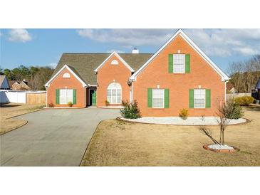Charming single-story brick home featuring a well-maintained yard and inviting green shutters at 502 Stoneland Pl, Lawrenceville, GA 30046