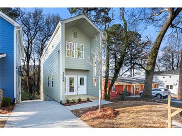 Charming two-story home with a modern design and well-maintained front yard and a long driveway at 2668 Brown Nw St, Atlanta, GA 30318
