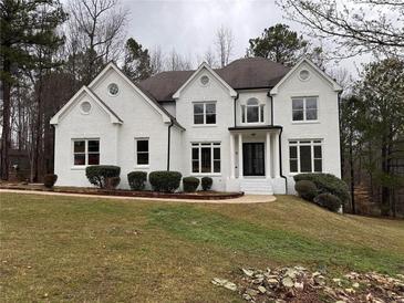 Charming two-story home with a classic brick facade and manicured landscaping at 408 Midway Pt, Ellenwood, GA 30294