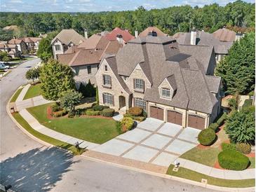 Stunning brick home featuring a three-car garage and professionally landscaped front yard at 1965 Carlotta Ct, Atlanta, GA 30345