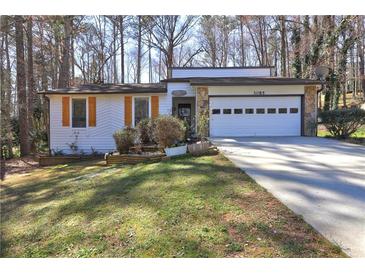 Charming single-story home featuring a stone facade, attached garage, and well-maintained front lawn at 3085 Nappa Trl, Stone Mountain, GA 30087