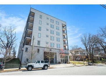 Modern apartment building with balconies, complemented by street parking and landscaped surroundings at 525 Parkway Ne Dr # 314, Atlanta, GA 30354