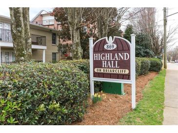 Sign for Highland Hall on Briarcliff with fresh landscaping in front of brick buildings and trees at 869 Briarcliff Ne Rd # B25, Atlanta, GA 30306