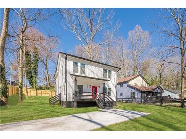 Charming two-story home with a well-manicured lawn and inviting front porch at 200 Adeline Nw Ave, Atlanta, GA 30314