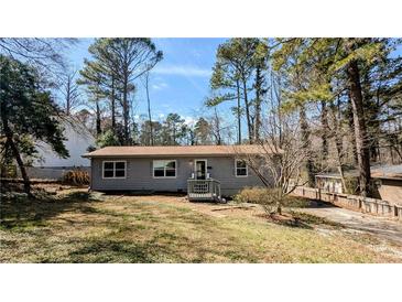 Charming single-story home with a well-maintained lawn and cozy front porch, surrounded by mature trees at 4195 Bradley Dr, Snellville, GA 30039