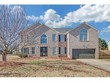 Charming two-story brick home with well-manicured lawn and attached two-car garage at 81 Sheffield Ln, Powder Springs, GA 30127