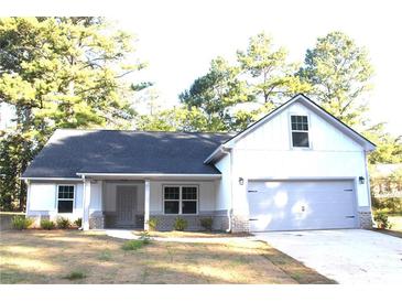 Charming single-Gathering home features neutral paint, attached garage, and inviting front porch at 84 Jennifer Ln, Covington, GA 30016