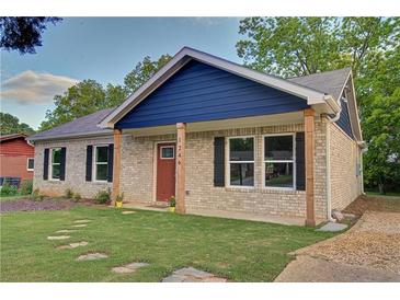 Charming single-story home with a well-manicured lawn and inviting front porch with natural wood supports at 1246 Bell Ave, East Point, GA 30344