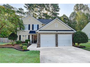 Charming two-story home featuring a well-maintained lawn, attached two-car garage, and inviting front entrance at 1171 Pine Acre Dr, Sugar Hill, GA 30518