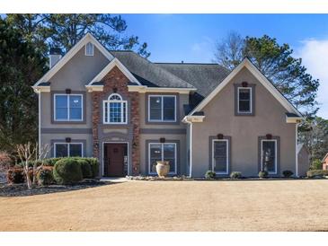 Charming two-story home showcasing a well-manicured lawn and welcoming front entrance at 1278 Crown Ter, Marietta, GA 30062