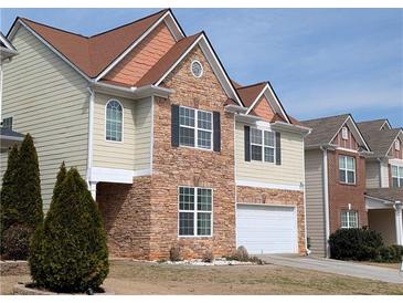 Charming two-story home with stone accents, neat lawn and a two car garage at 735 Briarhurst Ct, Lawrenceville, GA 30046