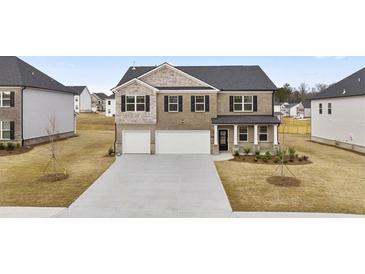 Beautiful two-story brick home with a two-car garage and well-manicured lawn at 1038 Blue Juniper Cir, Loganville, GA 30052