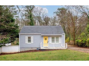 Charming single-story home with a yellow front door and freshly landscaped lawn at 1707 Terry Mill Road Se Rd, Atlanta, GA 30316