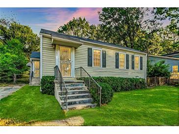 Charming single-story home featuring a well-manicured lawn, and inviting curb appeal at 1383 Almont Sw Dr, Atlanta, GA 30310