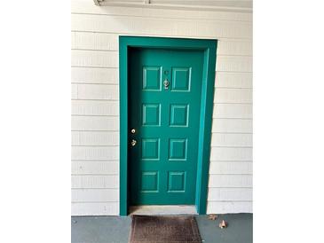 Stylish teal front door with classic hardware and sidelight paneling for a welcoming entrance at 9400 Roberts Dr # 6C, Atlanta, GA 30350