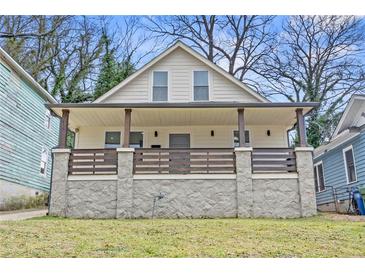 Charming renovated home featuring a covered front porch and stone foundation at 966 Ashby Grove Sw St, Atlanta, GA 30314