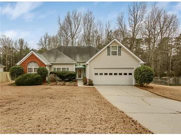 Charming single-story home with a well-manicured lawn and attached two-car garage at 1584 Snow Hill Dr, Lawrenceville, GA 30045