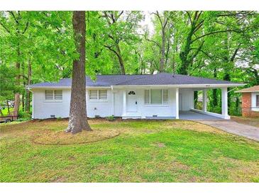 Charming one-story home with well-maintained lawn and a covered carport at 4973 White Blvd, Mableton, GA 30126