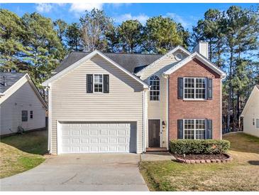 Charming two-story home featuring brick and siding, a manicured lawn, and an attached two-car garage at 414 Shadetree Ln, Lawrenceville, GA 30044