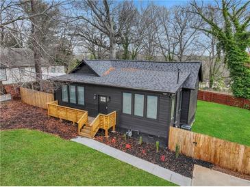 Charming home showcasing a new roof, dark siding, and a cozy wooden porch at 875 Center Hill Nw Ave, Atlanta, GA 30318