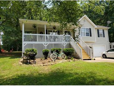 Charming two-story home featuring a covered porch, landscaped yard, and a fresh coat of exterior paint at 15 Winterville Dr, Rockmart, GA 30153