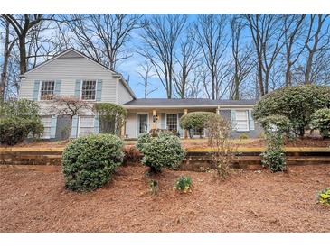 Charming two-story home with beautiful yard, fresh landscaping and light blue shutters at 291 Lamplighter Se Ln, Marietta, GA 30067