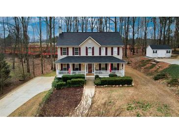 Charming two-story home with a welcoming front porch and well-maintained landscaping at 1049 Fieldstone Dr, Canton, GA 30114