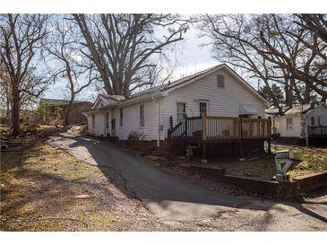 Charming home featuring a deck and well-lit surroundings and long driveway at 61 Daisy Cir, Canton, GA 30114