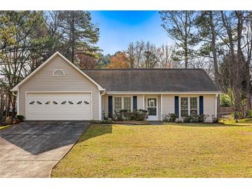 Charming home with a well-manicured lawn, two car garage, and inviting curb appeal at 1107 Sanfords Walk, Tucker, GA 30084