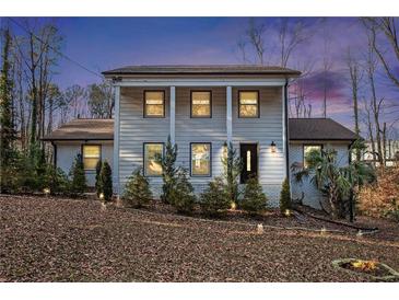 Charming two-story home with a welcoming front porch and beautifully landscaped front yard at 5664 Colton Dr, Atlanta, GA 30342