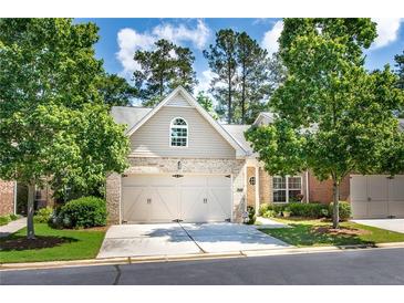 Charming home featuring a two-car garage, brick accents, and a well-manicured lawn with mature trees at 3916 Abbott Way # 2, Powder Springs, GA 30127