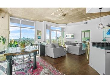 Bright open living room with city views, hardwood floors, and modern furnishings at 250 Pharr Ne Rd # 1618, Atlanta, GA 30305