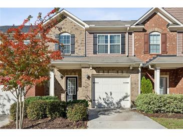 Charming townhome with brick facade, shuttered windows, covered entry, and attached one car garage at 3117 Haynes Park Dr, Lithonia, GA 30038