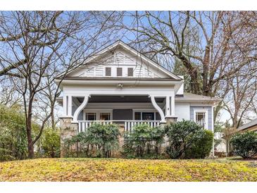 Charming bungalow with a welcoming front porch, stone accents, and mature trees enhancing the curb appeal at 1007 Blue Ridge Ne Ave, Atlanta, GA 30306