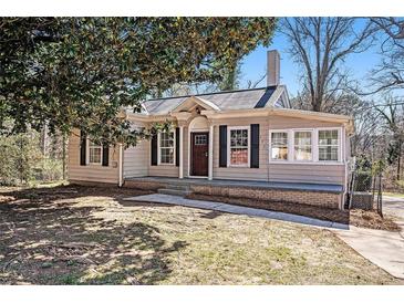Charming single-story home with neutral siding, black shutters, and well-maintained front lawn at 495 Hutchens Se Rd, Atlanta, GA 30354