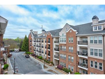 Upscale condominium exterior featuring a brick facade, multiple balconies, and well-maintained landscaping at 1850 Cotillion Dr # 3222, Atlanta, GA 30338