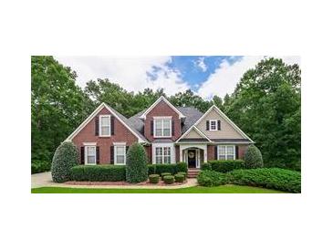 Charming two-story brick home with manicured landscaping, black shutters, and a welcoming front entrance at 2995 Barimore, Dacula, GA 30019