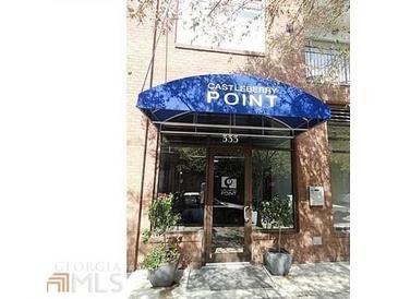 The building's entrance features the business name over the door, potted plants, and large glass windows at 333 Nelson Sw St # 214, Atlanta, GA 30313