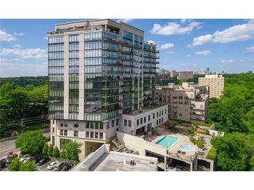 Modern high-rise condo with glass windows, green trees, and resort-style pool at 2233 Peachtree Ne Rd # 1202, Atlanta, GA 30309