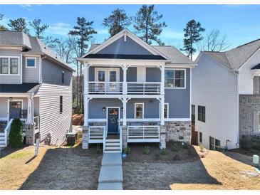 Charming two-story home featuring a double porch, light blue siding and a stone foundation at 5293 Hearthstone St, Stone Mountain, GA 30083