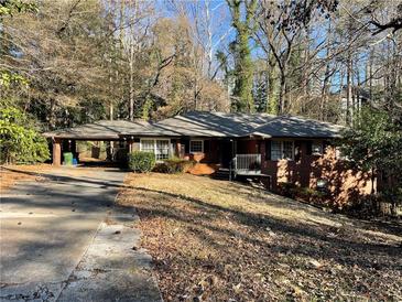 Charming brick home featuring an attached carport and a well-maintained front yard at 3683 N Stratford Ne Rd, Atlanta, GA 30342