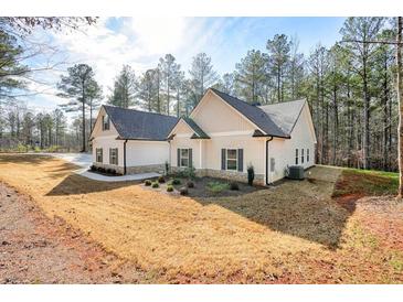 Charming house boasting board and batten siding and meticulously landscaped front yard at 1312 Mcgarity Rd, Temple, GA 30179