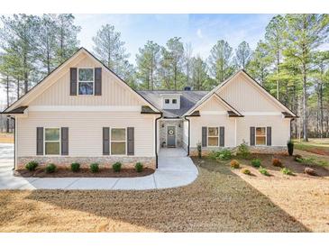 Charming single-Gathering home featuring stone accents and a welcoming front porch with a lovely front yard at 1312 Mcgarity Rd, Temple, GA 30179